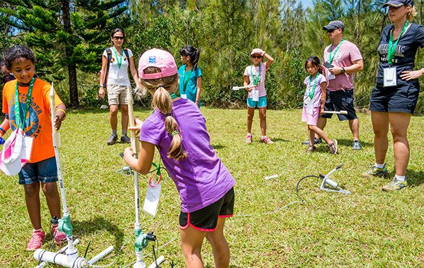 Girls launching rockets at camp