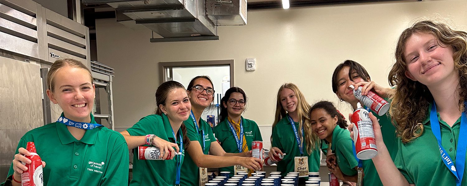 Girl Scouts preparing a meal at camp